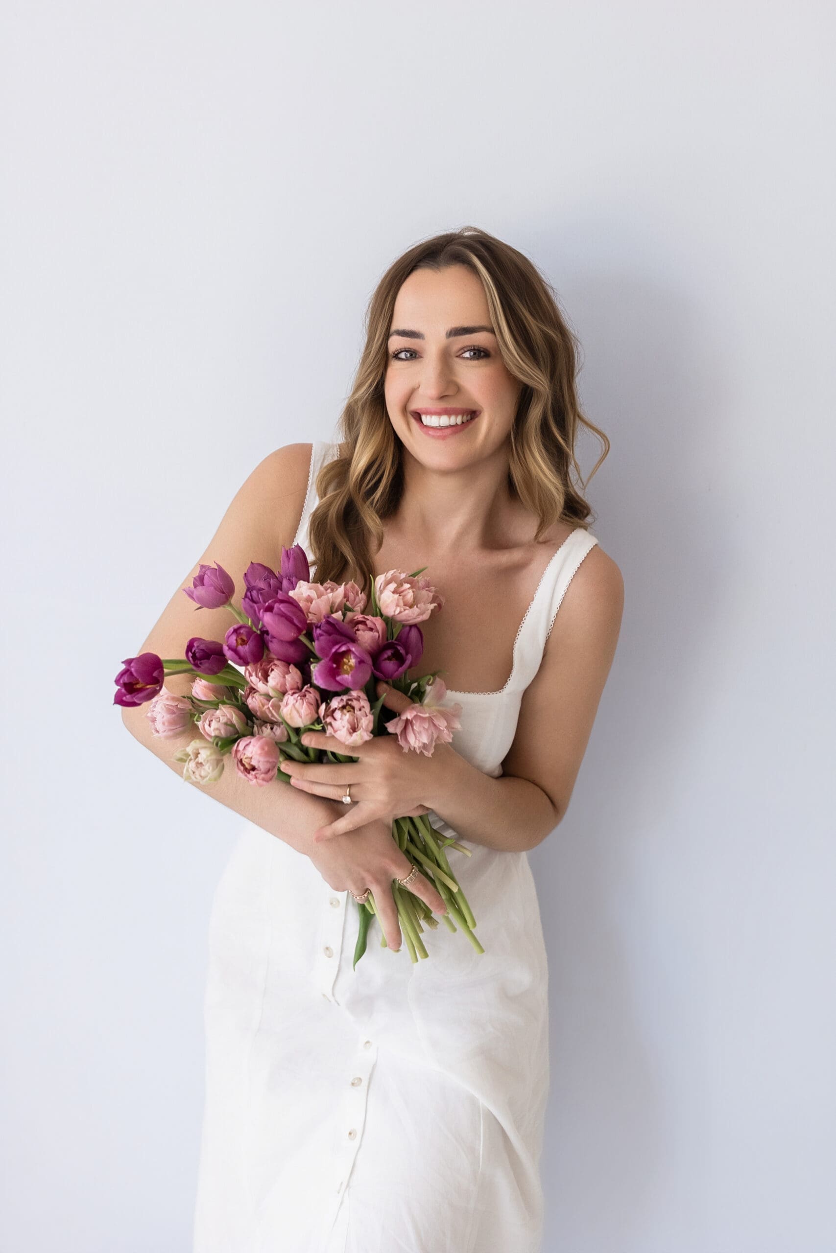 Professional women’s headshot with natural lighting showing confident business portrait and soft neutral background